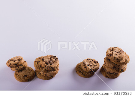 High angle view of cookies stacked over white background with copy space 93370583