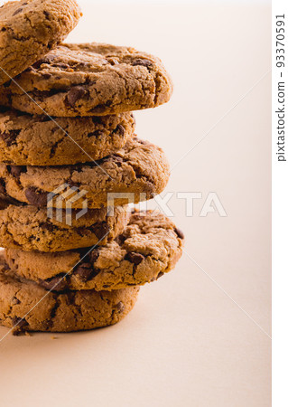 Close-up of stack of cookies on beige background with copy space Close-up of stack of cookies on beige background with copy space 93370591