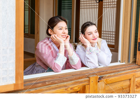 Experience Hanok, Korean traditional house_Korean and Caucasian girls looking out the window 93373327
