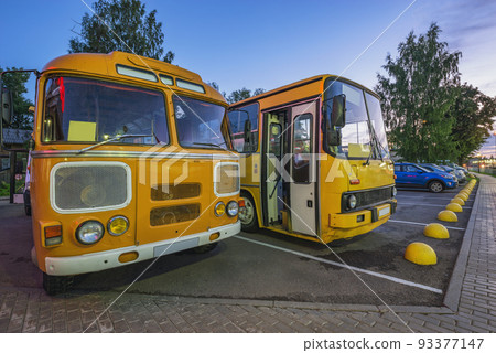 Retro buses stand on the morning street. 93377147