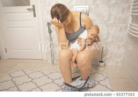 Tired depressed mother with crying newborn baby Tired depressed mother with crying newborn baby 93377383