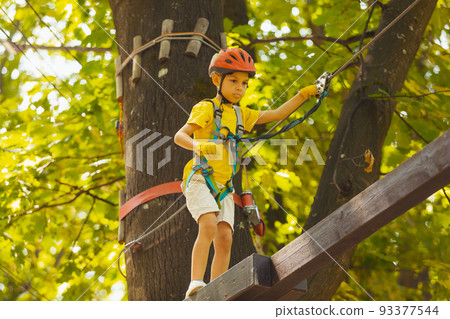 The cute preschooler are playing in the adventure park 93377544