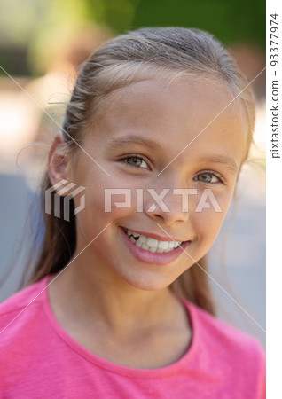 Face of pretty girl with toothy smile 93377974