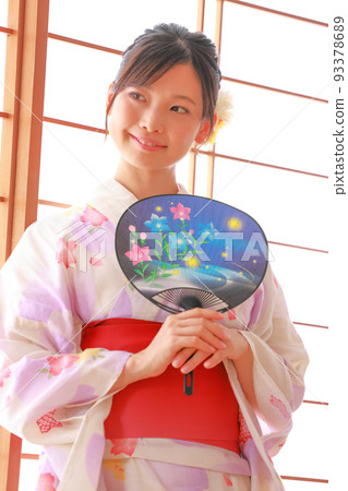 A woman in a yukata with a fan with a bellflower pattern by the shoji 1 A woman in a yukata with a fan with a bellflower pattern by the shoji 1 93378689