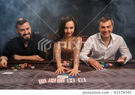 Group of a young rich friends are playing poker in casino. Group of a young rich friends are playing poker in casino. 93379345
