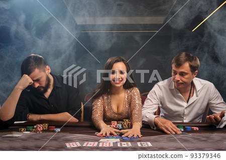 Group of a young rich friends are playing poker in casino. Group of a young rich friends are playing poker in casino. 93379346