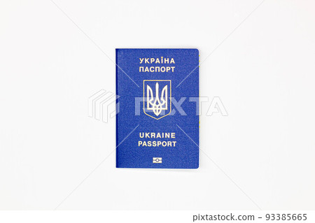 Passport of Ukraine. The cover of the State document of the foreign Ukrainian Passport with the coat of arms of Ukraine in blue on a white background with an electronic chip. Isolated. Top view Passport of Ukraine. The cover of the State document of the foreign Ukrainian Passport with the coat of arms of Ukraine in blue on a white background with an electronic chip. Isolated. Top view 93385665