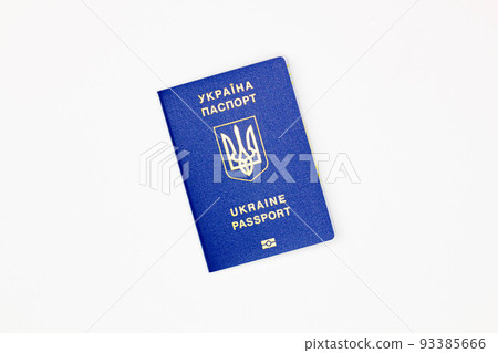 Passport of Ukraine. The cover of the State document of the foreign Ukrainian Passport with the coat of arms of Ukraine on a white background with an electronic chip. Isolated. Image at an angle 93385666