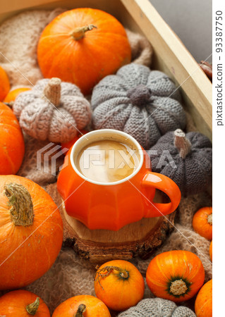 Autumn composition - Pumpkin Spice Latte, decorative knitted and natural pumpkin on warm plaid background, creative flat lay, top view, copy space. Seasonal fall concept with coffee drink 93387750
