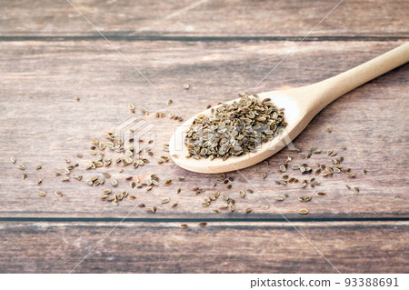 Dill seeds on wooden spoon, copy space Dill seeds on wooden spoon, copy space 93388691