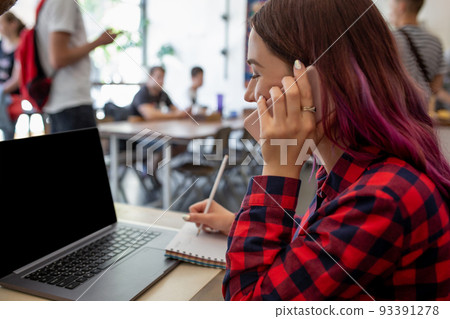 Woman typing on notebook with blank screen with copy space for your text or advertising content, sitting at wooden table 93391278