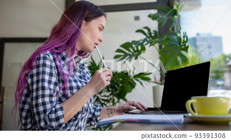 Woman typing on notebook with blank screen with copy space for your text or advertising content, sitting at wooden table 93391308
