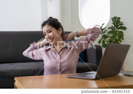 A business woman working in an office stretches to relax from work during breaks at home A business woman working in an office stretches to relax from work during breaks at home 93391333
