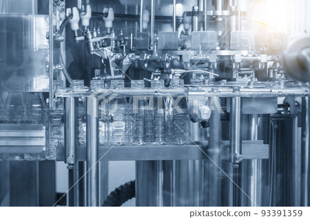 The empty water bottles on the conveyor belt for filling process in the drinking water factory. 93391359