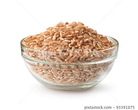 Glass bowl of organic spelt wheat grains 93391875