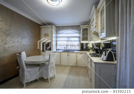 White classic cozy kitchen and dining room in city house White classic cozy kitchen and dining room in city house 93392215