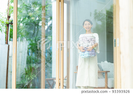 Woman with laundry basket 93393926