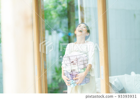 Woman with laundry basket 93393931
