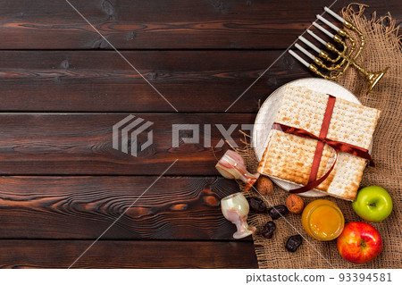 Jewish holiday Passover banner design with wine, matzo on wooden background. Jewish holiday Passover banner design with wine, matzo on wooden background. 93394581