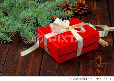 Christmas decoration, gift box and pine tree branches on wooden background 93394693