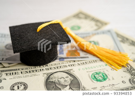 Graduation gap hat on US dollar banknotes money, Education study fee learning teach concept. 93394853