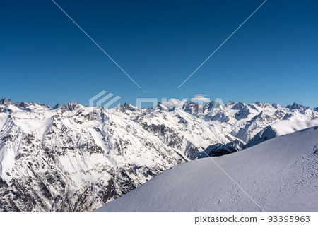 Mountain peaks covered with snow in winter. Mountain range in Caucasus region in Russia Mountain peaks covered with snow in winter. Mountain range in Caucasus region in Russia 93395963