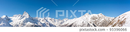 Panoramic view of winter snowy mountains in Caucasus region in Russia with blue sky 93396066