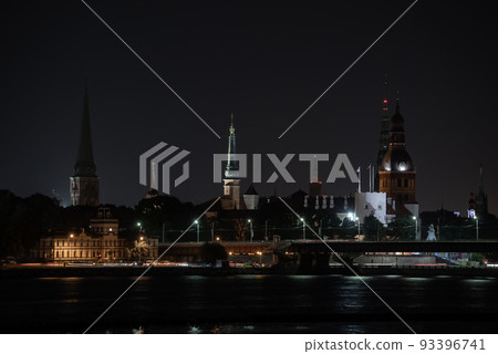 Panorama of the night Riga, Latvia. Panoramic view of city Riga with a St. Peters Church in foreground. Long exposure night photography 93396741