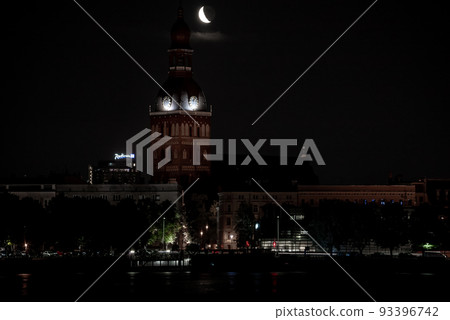 Beautiful quarter moon over Riga old town behind Domes cathedral clock. Night sky with amazing moon. Beautiful quarter moon over Riga old town behind Domes cathedral clock. Night sky with amazing moon. 93396742