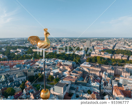 Beautiful aerial view of Riga city, the capital of Latvia. Aerial view of the old town of Riga and the golden cock on top of the St. Peter's Church. 93396777