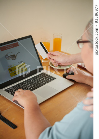 Grandson paying for purchases his grandmother makes online Grandson paying for purchases his grandmother makes online 93396977