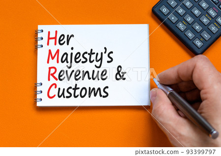 HMRC her majestys revenue and customs symbol. Concept words HMRC her majestys revenue and customs on white note on beautiful orange background. Business HMRC revenue and customs concept. Copy space. 93399797
