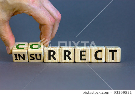Correct vs insurrect symbol. Businessman hand turns wooden cubes and changes the word 'insurrect' to 'correct'. Beautiful grey background, copy space. Business, correct vs insurrect concept. 93399851