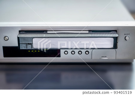 Combined VHS and CD player. playing old VHS cassettes, old electrical and electronic devices, old-fashioned media players. 93401519