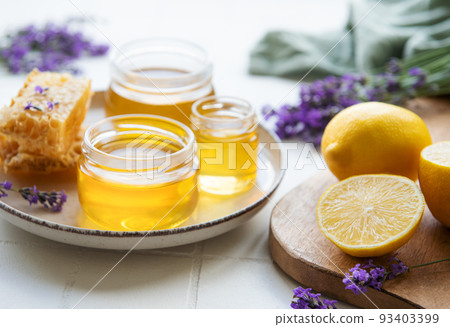 Jar with honey and fresh lavender flowers 93403399
