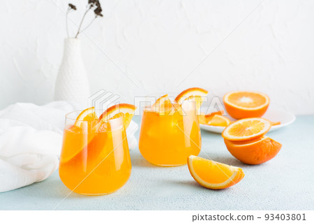 Hard seltzer cocktail with orange in glasses on the table. Homemade drink. Copy space 93403801