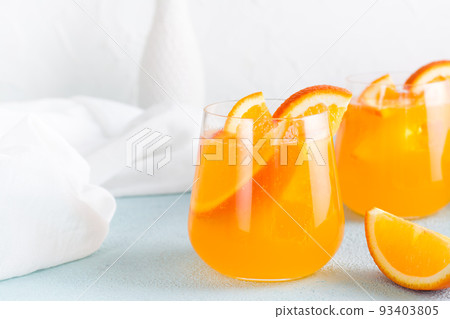 Hard seltzer refreshing orange cocktail in glasses on a table. Homemade drink. Copy space Hard seltzer refreshing orange cocktail in glasses on a table. Homemade drink. Copy space 93403805