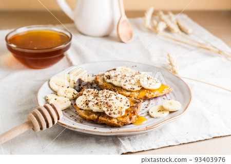Ready to eat sandwiches with honey, banana and chocolate on a plate on the table. Homemade vegetarian snack Ready to eat sandwiches with honey, banana and chocolate on a plate on the table. Homemade vegetarian snack 93403976