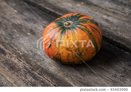 Orange squash pumpkin on rustic wooden boards 93403990