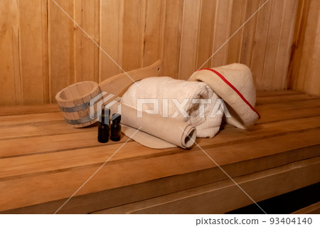 Traditional old Russian bathhouse SPA Concept. Interior details Finnish sauna steam room with traditional sauna accessories set basin towel aroma oil scoop felt. Relax country village bath concept Traditional old Russian bathhouse SPA Concept. Interior details Finnish sauna steam room with traditional sauna accessories set basin towel aroma oil scoop felt. Relax country village bath concept 93404140