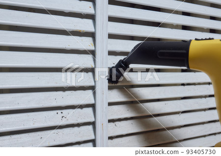 Cleaning company. girl with a steam cleaner brushing the home battery. We begin cleaning of the apartment. House worker. Leisure in gloves. We kill microbes and rust. Cleaning company. girl with a steam cleaner brushing the home battery. We begin cleaning of the apartment. House worker. Leisure in gloves. We kill microbes and rust. 93405730