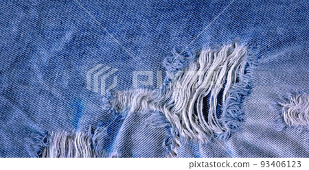 Hole and threads on denim jeans 93406123