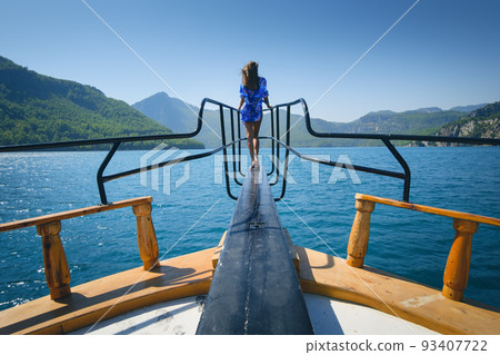 Young woman on the floating yacht on the sea at sunny bright day 93407722