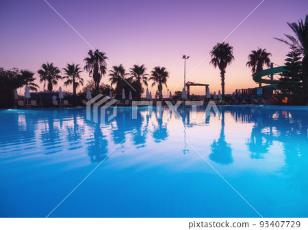 Beautiful reflection in swimming pool at colorful sunset 93407729