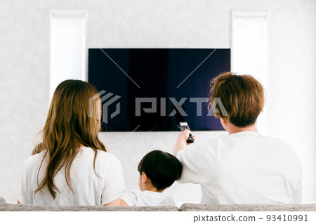 Family (children) watching TV in the living room at home 93410991