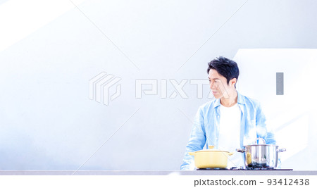 A man relaxing in the kitchen A man relaxing in the kitchen 93412438