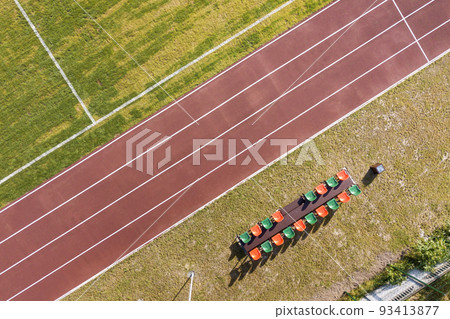 Top view of red running tracks and green grass lawn. Infrastructure for sports activities. 93413877