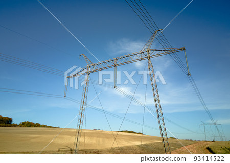 Steel pillar with high voltage electric power lines delivering electrical energy through cable wires on long distance Steel pillar with high voltage electric power lines delivering electrical energy through cable wires on long distance 93414522