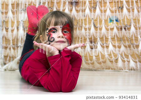 Portrait of pretty little girl with butterfly painting on her face 93414831