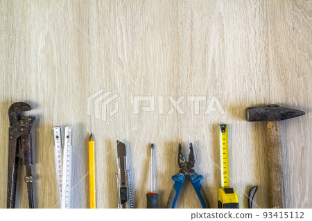 Construction, building and repair tools set for house work on wooden background. Top view. 93415112